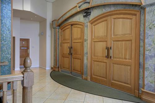 a large room with wooden cabinets and a rug at Sure Hotel by Best Western Aberdeen in Aberdeen
