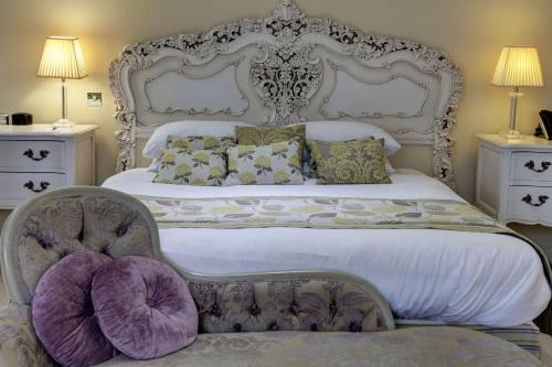 a bedroom with a large white bed and a chair at Best Western Plus Sheffield Mosborough Hall Hotel in Sheffield