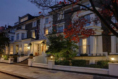 a large white building with lights in front of it at Best Western Swiss Cottage Hotel in London