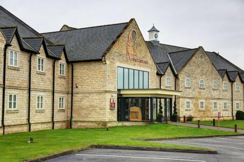 a large brick building with a black roof at Best Western Plus Pastures Hotel in Doncaster