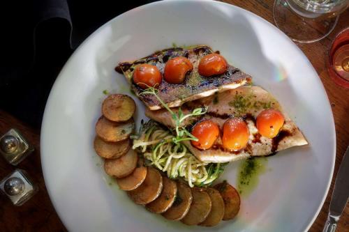 a plate of food with meat and vegetables on a table at Normanton Park Hotel, Sure Hotel Collection by Best Western in Oakham