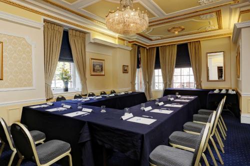 a conference room with tables and chairs and a chandelier at Best Western Plus West Retford Hotel in Retford