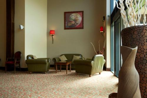 a waiting room with couches and chairs in a building at Best Western Plus Pastures Hotel in Doncaster