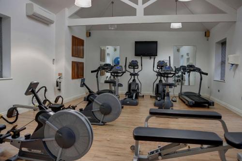 a gym with a bunch of exercise bikes at Best Western Plus Aston Hall Hotel in Aston