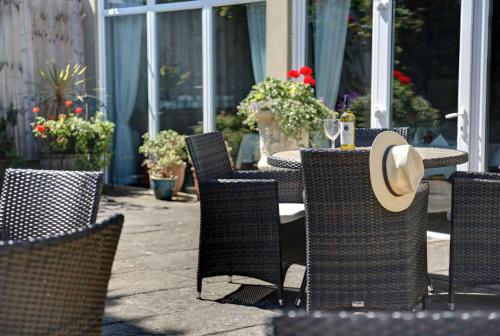 an outdoor table and chairs with a hat on it at Best Western Brook Hotel in Felixstowe