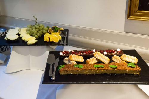 a cake on a black plate on a table at Hotel Kryb I Ly Kro in Taulov