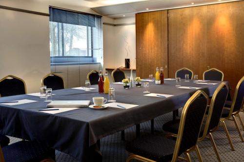 a conference room with a long table and chairs at Best Western Ipswich Hotel in Ipswich
