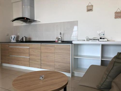 a kitchen with wooden cabinets and a table in a room at Heart of Bandar Baru Bangi (2) in Bangi