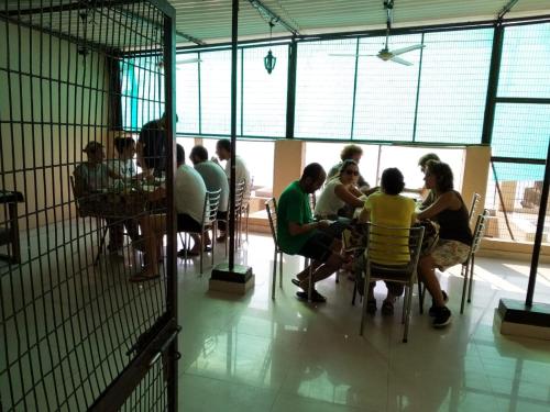 a group of people sitting at a table in a cage at Dwivedi Hotels Palace On Steps in Varanasi