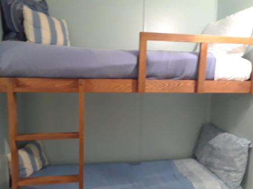 two bunk beds in a small room with a mattress at 'It's All Good!' in Corpus Christi