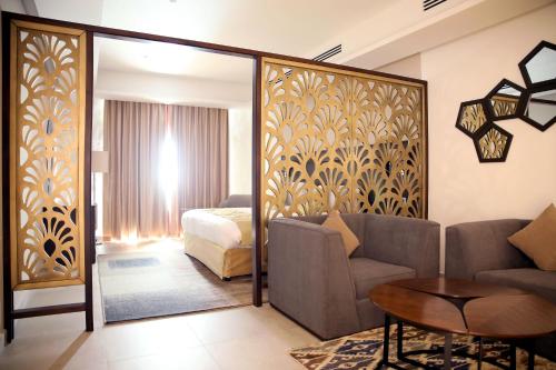 a living room with a couch and a bedroom at Downtown Hotel Apartments in Amman