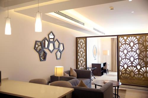a living room with a couch and a table at Downtown Hotel Apartments in Amman