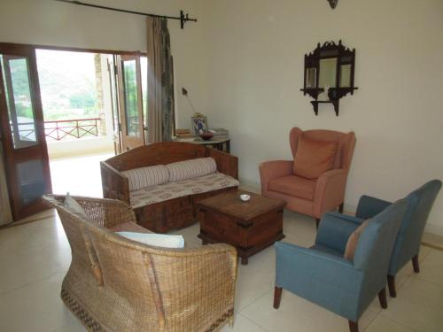 a living room with chairs and a couch at Devra Udaipur in Udaipur
