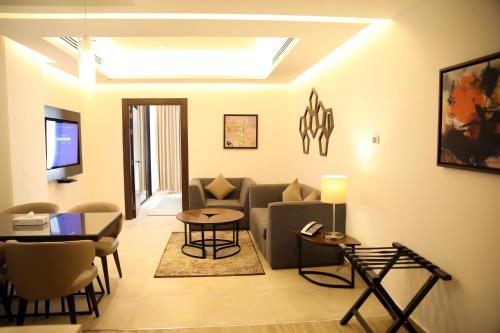 a living room with a couch and a table at Downtown Hotel Apartments in Amman