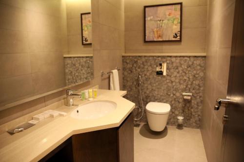 a bathroom with a sink and a toilet at Downtown Hotel Apartments in Amman