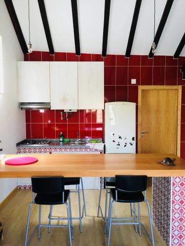 a kitchen with a large wooden table and chairs at casadaeiradeangeja in Angeja