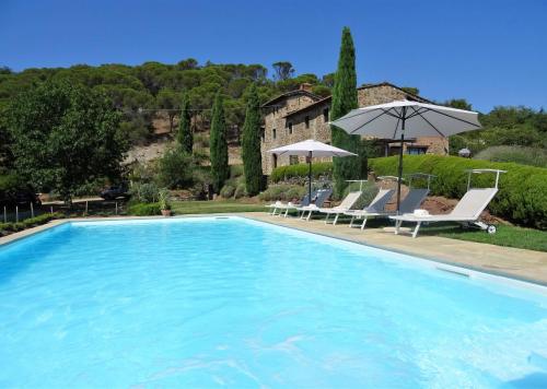 a large swimming pool with chairs and umbrellas at Il Poggetto in Greve in Chianti