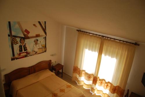 a bedroom with a bed and a window at Hotel Belvedere Tonara in Tonara