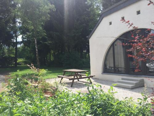 a picnic table in front of a building at Maison 25 in Houffalize