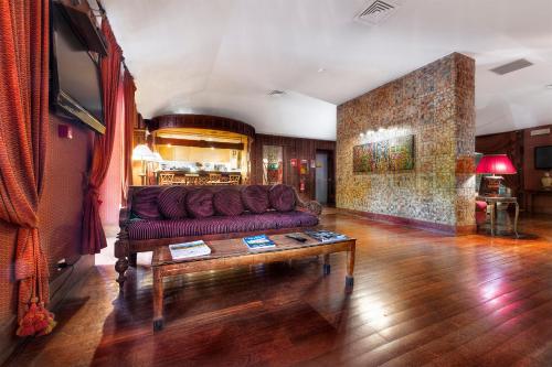 Grand Hotel Colony في روما: غرفة معيشة مع أريكة وطاولة قهوة