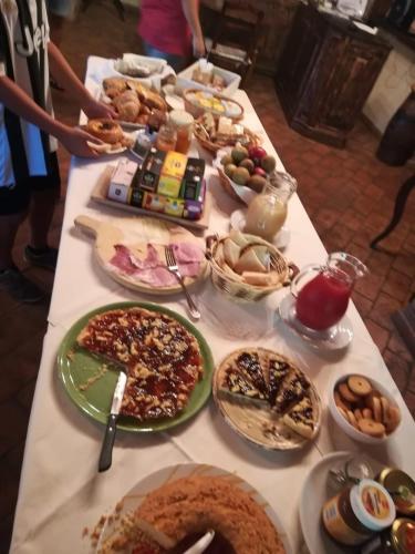 a long table with many plates of food on it at Società Agricola F.lli Angelucci in Cannara