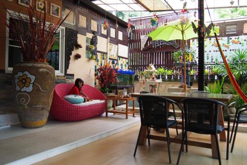 a person sitting in a red chair in a room at Wiang Kum Kam Resort in Chiang Mai