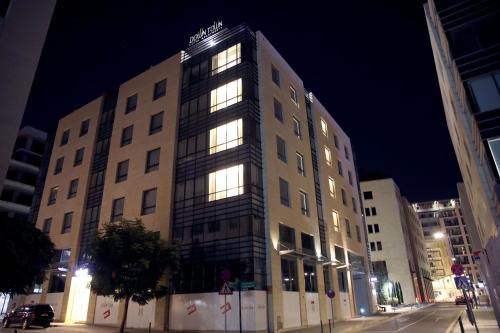 a building with lights on in a city at night at Downtown Hotel Apartments in Amman