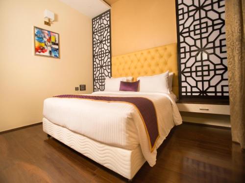 a bedroom with a large bed in a room at ST Parklane Airport Hotel Chennai in Chennai