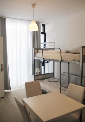 a living room with two bunk beds and a table at Hauptbahnhof S2 in Vienna