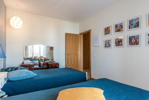 a bedroom with two beds with blue sheets at Varanda do Castelo - Charming Apartment in a Historical Town in Silves