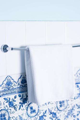 a blue and white bathroom with a roll of toilet paper at Pałac Krobielowice in Kąty Wrocławskie