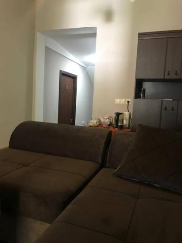 a couch sitting in a living room with a door at Guesthouse Chela in Mestia