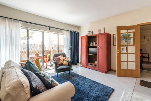 a living room with a couch and a chair at Varanda do Castelo - Charming Apartment in a Historical Town in Silves