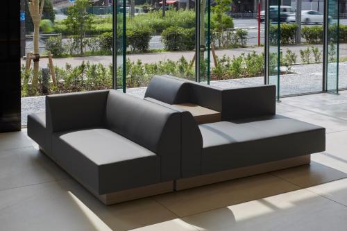 a couch sitting in a lobby with windows at Tmark City Hotel Tokyo Omori in Tokyo