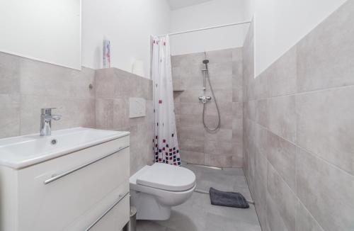 a bathroom with a shower and a toilet and a sink at DDC in Dziwnów