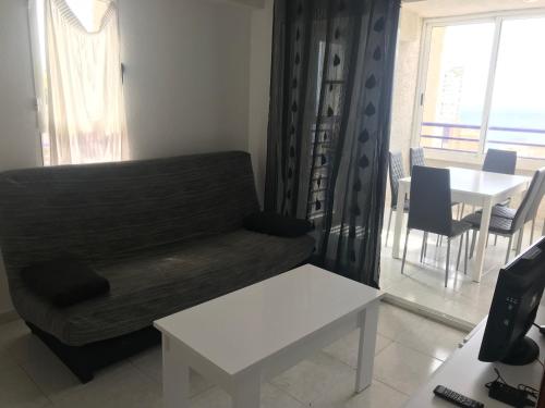 a living room with a couch and a table at Tropic Mar 2H in Benidorm