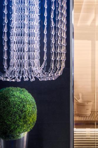 a chain hanging from a wall next to a plant at LHP Hotel Santa Margherita Palace & SPA in Santa Margherita Ligure