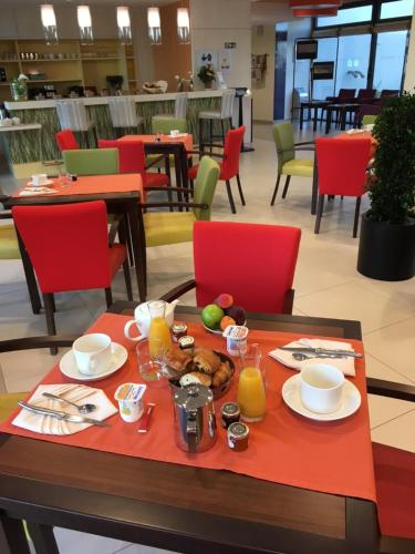 a table with a tray of breakfast food on it at Domitys Rosa Gallica in Angers