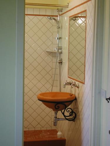 a bathroom with a wooden sink and a mirror at Agriturismo Santa Rosa in Subbiano