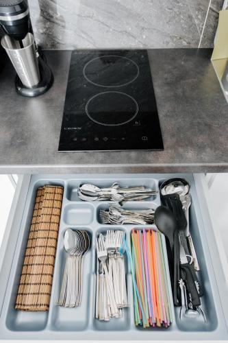 a tray filled with utensils on a kitchen counter at Nest Apartment in Athens