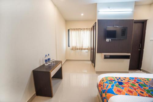 a hotel room with a bed and a tv at Hotel Suraj Palace in Udaipur