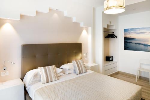 a bedroom with a large bed and a staircase at Sorrento Comfort Rooms con piscina in Sorrento