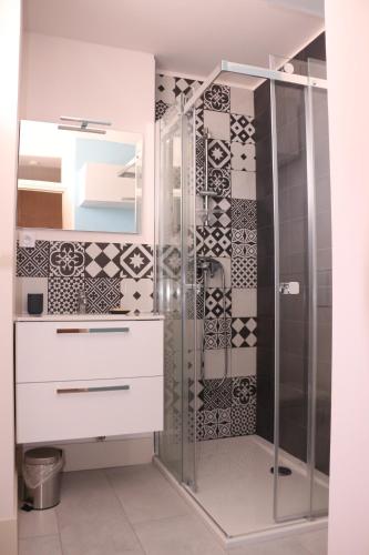 een badkamer met een douche en een wit dressoir bij Studio Palavas proche plage in Palavas-les-Flots