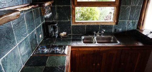 a small kitchen with a sink and a window at Marinas Alto Manzano in Villa La Angostura