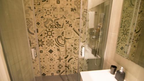 a bathroom with a shower with a toilet and a sink at Apartamentos Panorámicos Don Miguel II in Benidorm