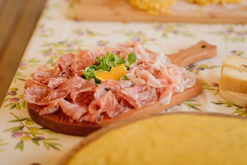 a plate of food with meat and vegetables on a table at Agriturismo Spigolo in Avesa