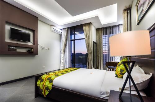 a hotel room with a bed and a window at The Venti Hotel & Spa in Kampala