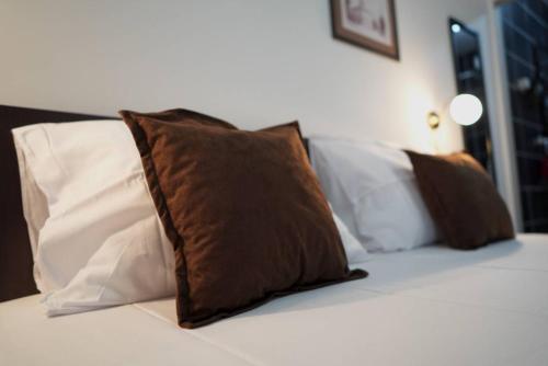 a group of pillows sitting on top of a bed at Apartments & Dream Rooms in Niš