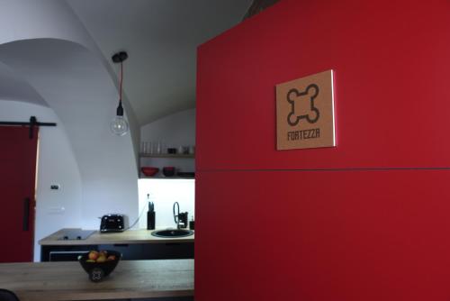 a red refrigerator with a sign on it in a kitchen at Fortezza Ljubljana Center in Ljubljana