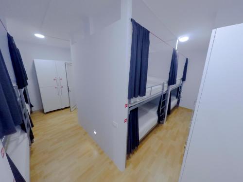 a room with two beds and a mirror at ART Hostel in Tirana